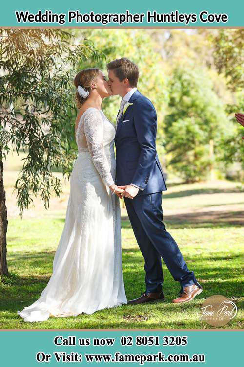 Photo of the Bride and the Groom kissing at the yard Huntleys Cove NSW 2111