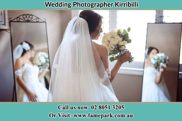 Photo of the Bride holding flower at the front of the mirrors Kirribilli NSW 2061