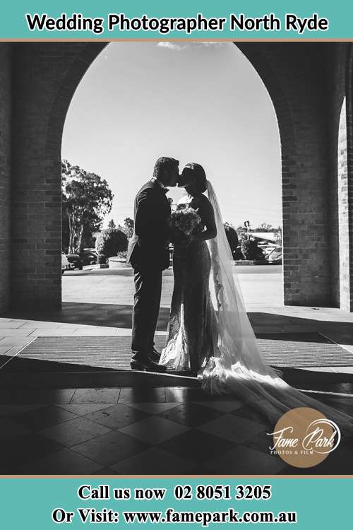 Photo of the Groom and the Bride kissing at the front of the church North Ryde NSW 2113